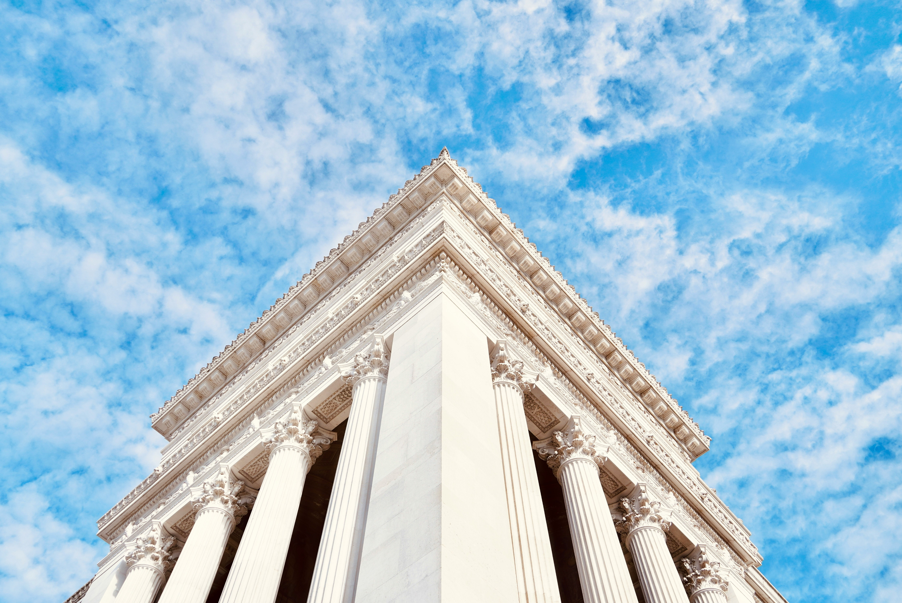 Classical white stone building with columns reaching into the sky